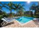 Enjoy the pool and spa with lounge chairs and tropical landscaping, perfect for outdoor relaxation and fun at 291 Pendant Ct, Kissimmee, FL 34747