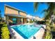 A serene backyard oasis with a sparkling pool, jacuzzi, lounge chairs, and lush landscaping at 291 Pendant Ct, Kissimmee, FL 34747