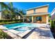 Sparkling pool and spa featuring a sun deck, landscaped yard, and outdoor seating area for relaxation at 291 Pendant Ct, Kissimmee, FL 34747