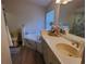 Bathroom with a soaking tub with marbled tile and double vanity at 3020 Norlina St, Deltona, FL 32738
