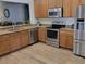 Modern kitchen with stainless steel appliances, granite countertops, and a breakfast bar at 3020 Norlina St, Deltona, FL 32738