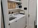 The laundry room features a white washer and dryer and shelving at 3020 Norlina St, Deltona, FL 32738