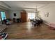 Spacious living room with hardwood floors, tray ceiling, and ample natural light from the large window at 3020 Norlina St, Deltona, FL 32738
