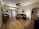 Comfortable living room with hardwood floors, ceiling fan, and sliding glass doors at 3020 Norlina St, Deltona, FL 32738