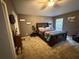 Comfortable bedroom with plush carpeting, a large bed, and natural light from the window at 3020 Norlina St, Deltona, FL 32738