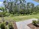 Picturesque backyard featuring lush greenery and brick pavers for outdoor enjoyment at 3024 Meleto Blvd, New Smyrna Beach, FL 32168