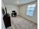 Neutral carpeted bedroom featuring a desk, computer, and a bright window at 3024 Meleto Blvd, New Smyrna Beach, FL 32168