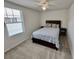 Cozy bedroom with neutral tones, carpet, ceiling fan, and natural light from a window at 3024 Meleto Blvd, New Smyrna Beach, FL 32168