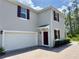Two-story home with an attached two-car garage and brick-paved driveway at 3024 Meleto Blvd, New Smyrna Beach, FL 32168