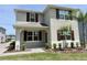 Inviting two-story home featuring well-kept landscaping and a cozy, covered entry at 3024 Meleto Blvd, New Smyrna Beach, FL 32168