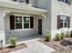 Close up of a charming covered porch with manicured landscaping and attractive brick pavers at 3024 Meleto Blvd, New Smyrna Beach, FL 32168