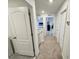 Upstairs hallway with neutral colored carpet and access to bedrooms at 3024 Meleto Blvd, New Smyrna Beach, FL 32168