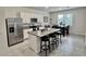 Modern kitchen featuring a large island, stainless steel appliances, and an adjacent dining area at 3024 Meleto Blvd, New Smyrna Beach, FL 32168
