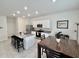 Well-lit open kitchen featuring an island with bar stools and modern stainless steel appliances at 3024 Meleto Blvd, New Smyrna Beach, FL 32168