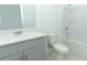 Bathroom featuring quartz countertops, vanity with gray cabinets and shower and bathtub combo at 326 Wayland Dr, Haines City, FL 33844