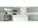 Modern kitchen featuring stainless steel appliances, gray cabinets, and a central island at 326 Wayland Dr, Haines City, FL 33844