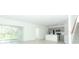 Open-concept living space featuring a kitchen, large sliding doors, and modern stairs at 326 Wayland Dr, Haines City, FL 33844