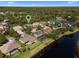 Aerial view of a property with a pool, solar panels, and a backyard overlooking a pond at 3428 Deer Oak Cir, Oviedo, FL 32766