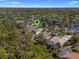 Aerial view of a home with a pool in a lush community with mature trees and lakes nearby at 3428 Deer Oak Cir, Oviedo, FL 32766