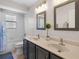 Bathroom featuring a tub/shower combo, double vanity and framed mirrors at 3428 Deer Oak Cir, Oviedo, FL 32766