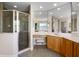 Bathroom featuring a glass shower, vanity with makeup station, mirrors and vanity at 3428 Deer Oak Cir, Oviedo, FL 32766