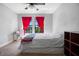 Bedroom featuring a bed, colorful decorations, bright red curtains and carpet flooring at 3428 Deer Oak Cir, Oviedo, FL 32766