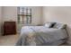 Cozy bedroom with a large window, soft carpet, and a wooden dresser at 3428 Deer Oak Cir, Oviedo, FL 32766