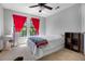 Bedroom featuring a bed, colorful decorations, bright red curtains and carpet flooring at 3428 Deer Oak Cir, Oviedo, FL 32766