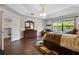 Spacious bedroom with a large window offering scenic views and a cozy sitting area at 3428 Deer Oak Cir, Oviedo, FL 32766