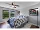 Bedroom includes a ceiling fan, 2 windows and a football-themed art print at 3428 Deer Oak Cir, Oviedo, FL 32766