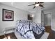 Relaxing bedroom with dark wood floors, a ceiling fan, and stylish black and white decor at 3428 Deer Oak Cir, Oviedo, FL 32766
