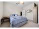 Relaxing bedroom with soft carpet, a ceiling fan, and decorative wall mirror at 3428 Deer Oak Cir, Oviedo, FL 32766