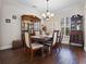 Elegant dining room with hardwood floors, china cabinet, and chandelier at 3428 Deer Oak Cir, Oviedo, FL 32766
