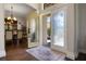 Inviting foyer with hardwood floors, glass-paneled front doors, and an elegant dining room at 3428 Deer Oak Cir, Oviedo, FL 32766
