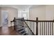 Open hallway upstairs featuring dark wood flooring and a round window for natural light at 3428 Deer Oak Cir, Oviedo, FL 32766