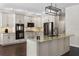 Contemporary kitchen featuring gray cabinetry, stainless steel appliances, and granite countertops at 3428 Deer Oak Cir, Oviedo, FL 32766