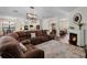 Open-concept living area featuring a fireplace, view into kitchen, and large sectional sofa for comfortable seating at 3428 Deer Oak Cir, Oviedo, FL 32766