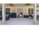 Covered patio featuring a grill, comfortable seating, ceiling fans, and backyard views at 3428 Deer Oak Cir, Oviedo, FL 32766