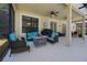 Covered patio with ceiling fans, comfortable seating, and an outdoor grill, perfect for entertaining at 3428 Deer Oak Cir, Oviedo, FL 32766