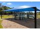 Community playground featuring modern climbing equipment, wood chip ground cover, and a blue shade structure at 3428 Deer Oak Cir, Oviedo, FL 32766