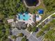 Aerial view of community pool and recreation area with a sand volleyball court and playground at 3428 Deer Oak Cir, Oviedo, FL 32766