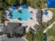 Aerial view of community pool with ample seating, a water slide, shaded tables, and a splash pad at 3428 Deer Oak Cir, Oviedo, FL 32766
