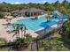 Community pool with palm trees, a water slide, and lounge chairs offers a resort-style amenity at 3428 Deer Oak Cir, Oviedo, FL 32766