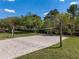 Outdoor sand volleyball court with a net and green grass, surrounded by trees at 3428 Deer Oak Cir, Oviedo, FL 32766