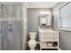 Tiled bathroom features a glass enclosed shower with stone accents and a modern vanity at 412 Stimson St, Orlando, FL 32839