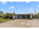 Single story home featuring a carport, mature landscaping, and a basketball hoop at 412 Stimson St, Orlando, FL 32839