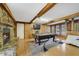 Recreational space with stone fireplace, pool table, wood paneling, and exposed beams at 412 Stimson St, Orlando, FL 32839