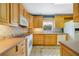 Bright kitchen with wood cabinets, tile backsplash, and modern appliances at 412 Stimson St, Orlando, FL 32839
