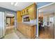 Well-lit kitchen with wood cabinets and a view into the adjacent dining area at 412 Stimson St, Orlando, FL 32839