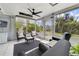Bright sunroom with tile floor, ceiling fan, and views of the well landscaped backyard at 412 Stimson St, Orlando, FL 32839